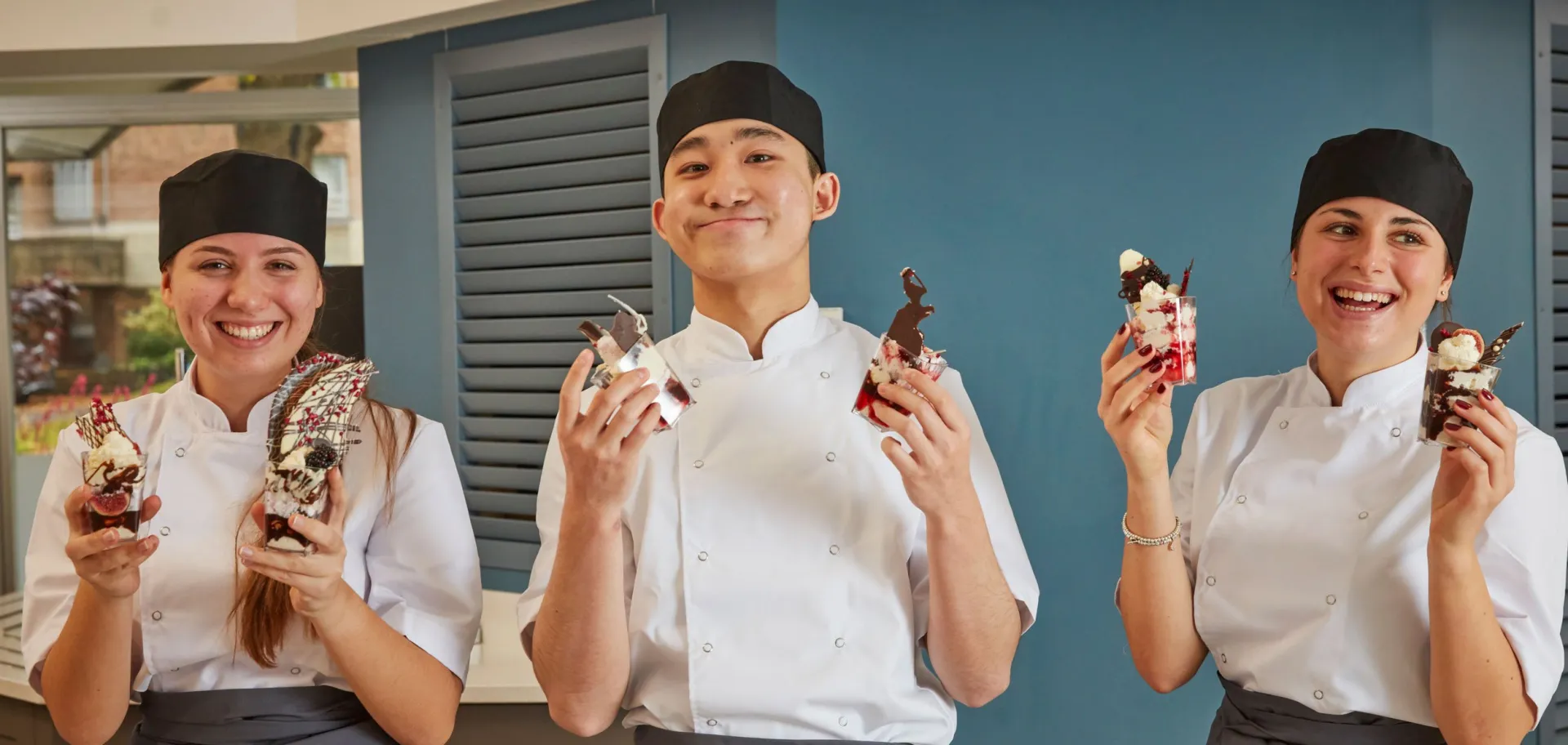 chefs holding desserts