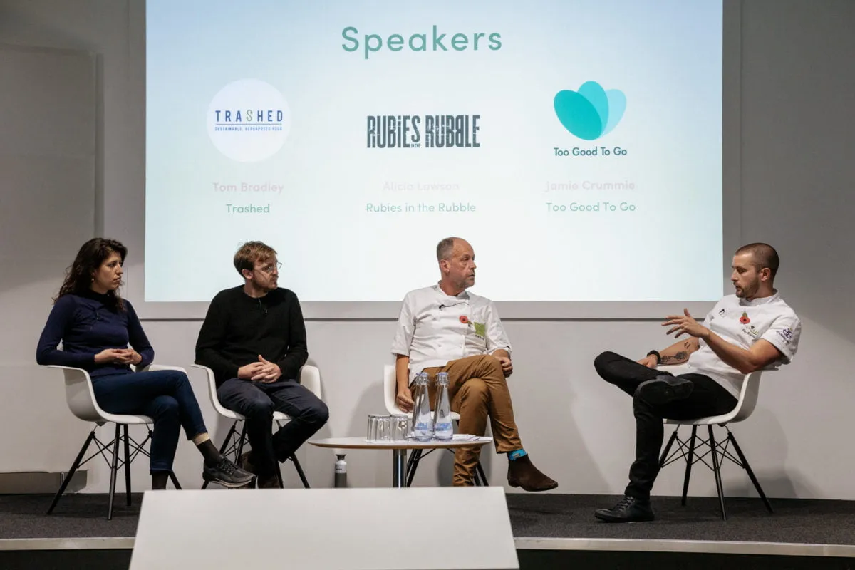 4 speakers sitting on stage