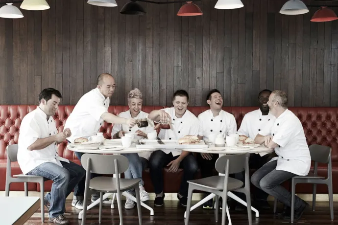 group of chefs eating at a restaurant table