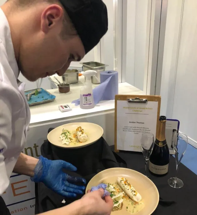 chef putting final touch on dish